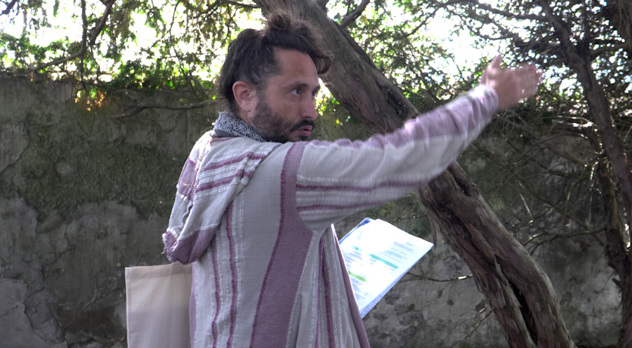 Dans le jardin Bossuet, avec un groupe de visiteurs, Christophe Alzetto joue le guide culturel dans sa performance parodique et réflexive Visite guidée